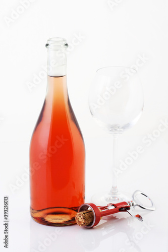 Close-up of rose wine on white background