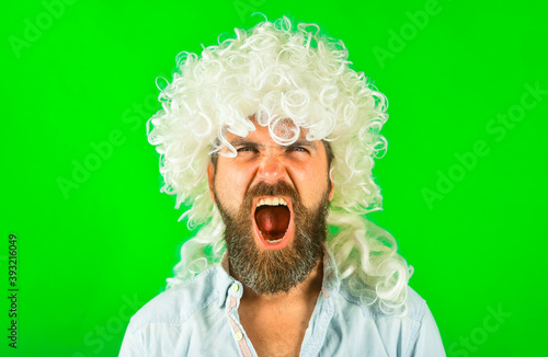 Screaming man portrait. Man in white wig. Brutal bearded man. Portrait of serious man. Isolated. Scream. Angry.