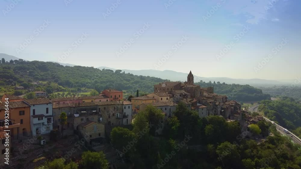 Old Italian town with red tile roofs. Drone shot over old beautiful villas in Tuscany, Italy. Big road and river are on the right. Old Italian town with red tile roofs. Drone shot over old beautiful villas in Tuscany, Italy. Big road and river are on the right.