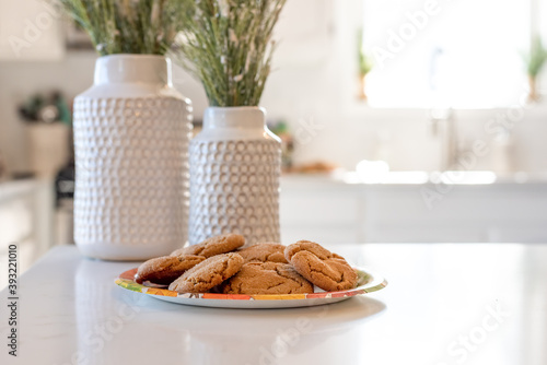 Homemade gingersnap cookies on the counter in a clean white kitchen photo