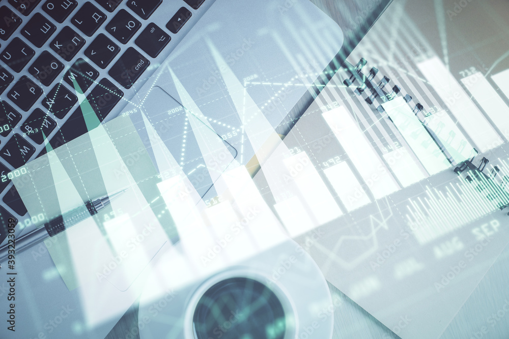 Fototapeta premium Stock market graph and top view computer on the table background. Double exposure. Concept of financial education.