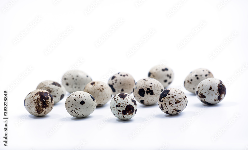Quail eggs isolated on white background. Group of quail eggs close-up isolated on a white background. Detailed closeup of spotted quail eggs