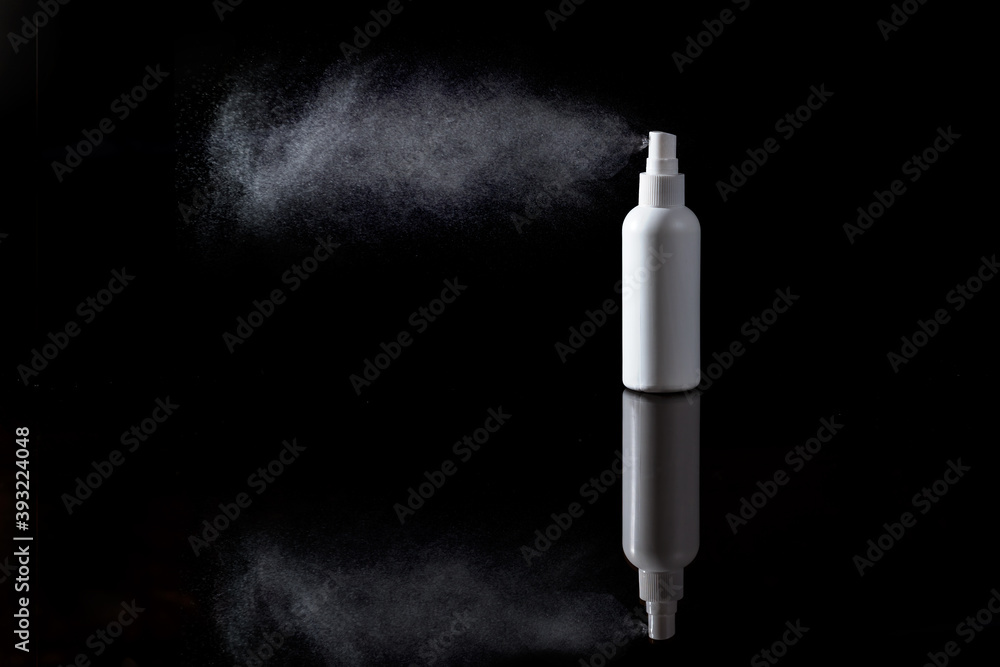Disinfectant spray plastic bottle on a reflective glass spraying - black background, clear reflection Disinfectant spray plastic bottle on a reflective glass spraying - black background, clear reflection