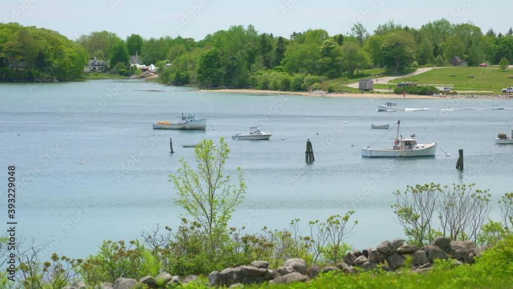 Beautiful shot of lobster boat returning to quaint Maine harbor Beautiful shot of lobster boat returning to quaint Maine harbor