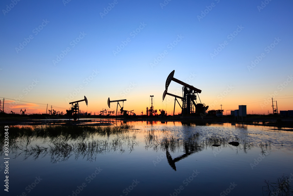 In the evening, oil pumps are running, Silhouette of beam pumping unit