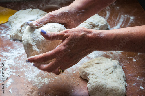 hands kneading dough on the table