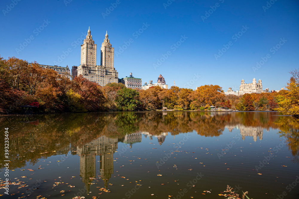 Trees and buildings reflect off the Lake in Central Park, New York City