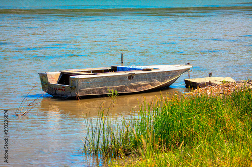 Moored fishing boat . Old fishing vessel at the water's edge 