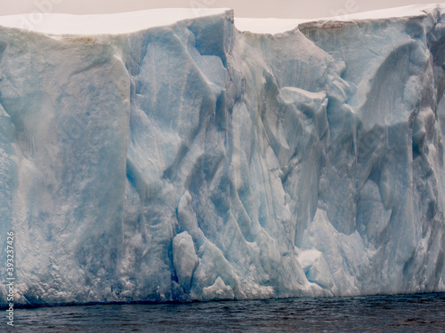 Close up of the edge of a tabular iceberg in Antarctica photo