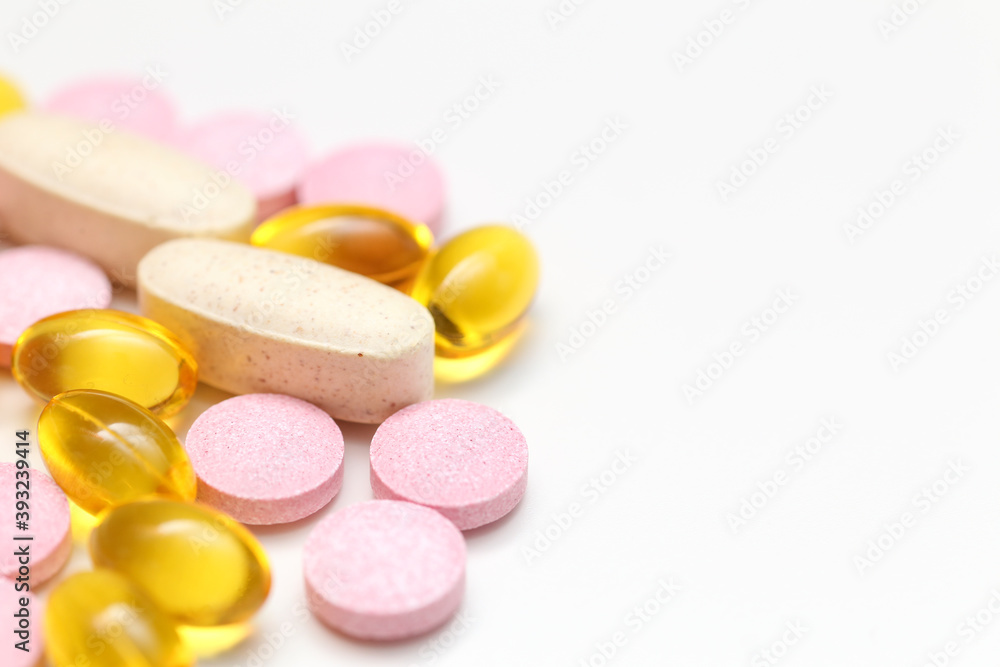 Close-up of VItamins D, B, and C in an Isolated Background. Drug Treatment Concept.
