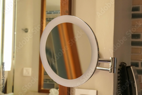 round women make up magnifying mirror with LED light in luxury bathroom