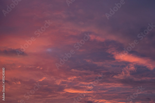 beautiful cloudy sky with pink, red orange and purple colour right after sunset © Yi