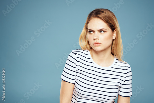 Blonde girl in striped t-shirt lifestyle blue background fun © SHOTPRIME STUDIO