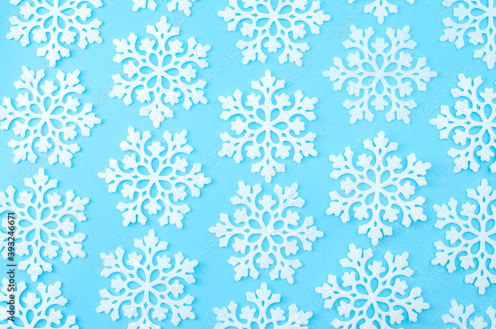 Christmas wallpaper and winter pattern concept with repeating snowflakes with every snowflake in different position isolated on pastel blue background Christmas wallpaper and winter pattern concept with repeating snowflakes with every snowflake in different position isolated on pastel blue background