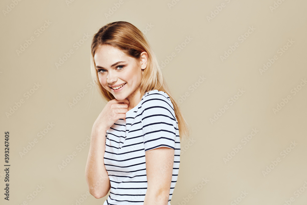 Obraz premium Cute blonde striped t-shirt smile lifestyle beige studio background