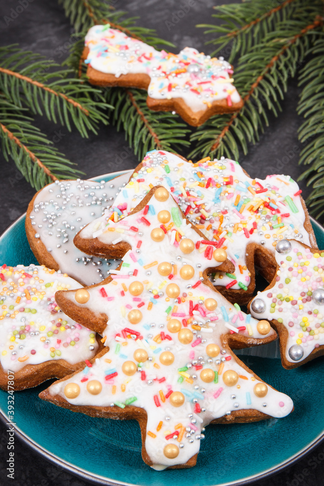 Fresh baked gingerbread with colorful decorations and spruce branches. Christmas time
