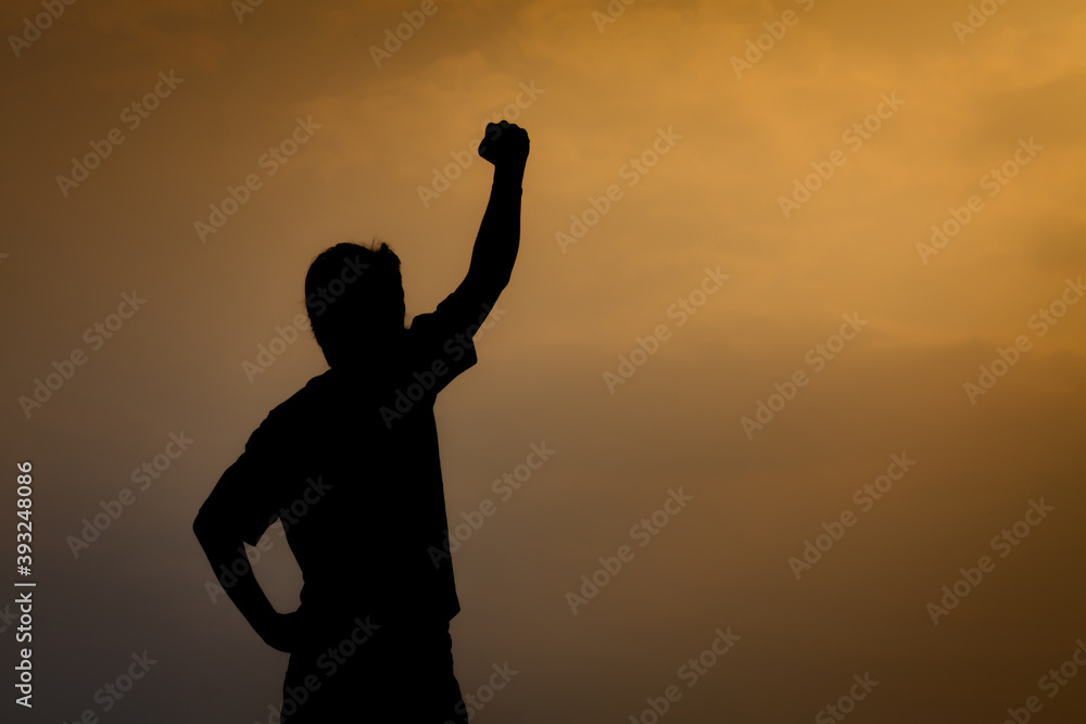 Silhouette of man on yellow sky background