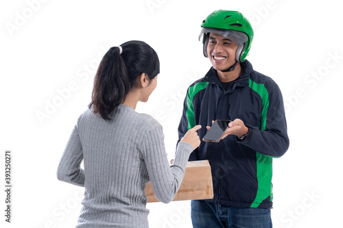 woman signing to package she received from delivery courier