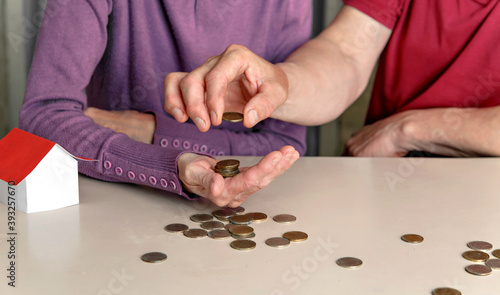 Woman and man distribute money in family budget