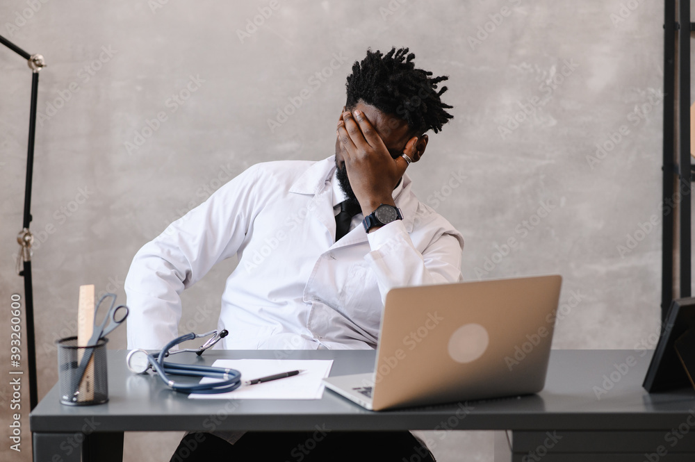 Funny bored at work african american doctor worker falling asleep at office desk, employee sleeping at workplace near laptop feel overworked concept Funny bored at work african american doctor worker falling asleep at office desk, employee sleeping at workplace near laptop feel overworked concept