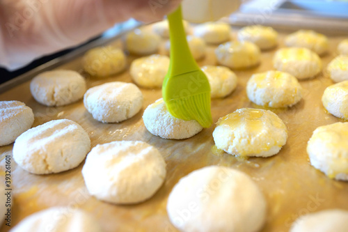 The process of making cheese cakes. Cheesecakes on a baking sheet before baking.