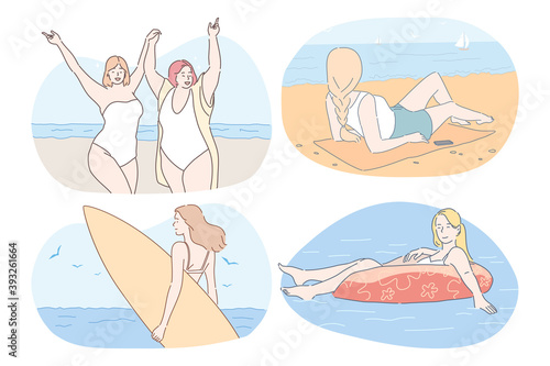 Vacations, traveling, summer holidays near sea concept. Young women in bikini sunbathing, swimming, surfing, relaxing and enjoying vacations on sea or ocean in summer during weekend 