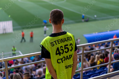 Steward at a football match, stadium photo