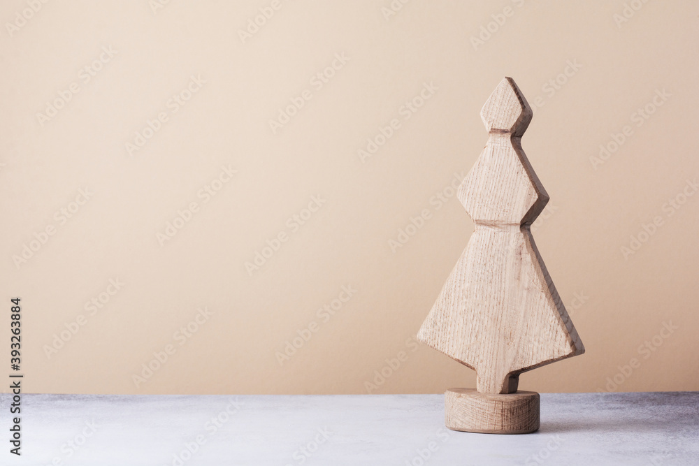Wooden decorative Christmas tree on a light background. Zero waste concept.. Wooden decorative Christmas tree on a light background. Zero waste concept..