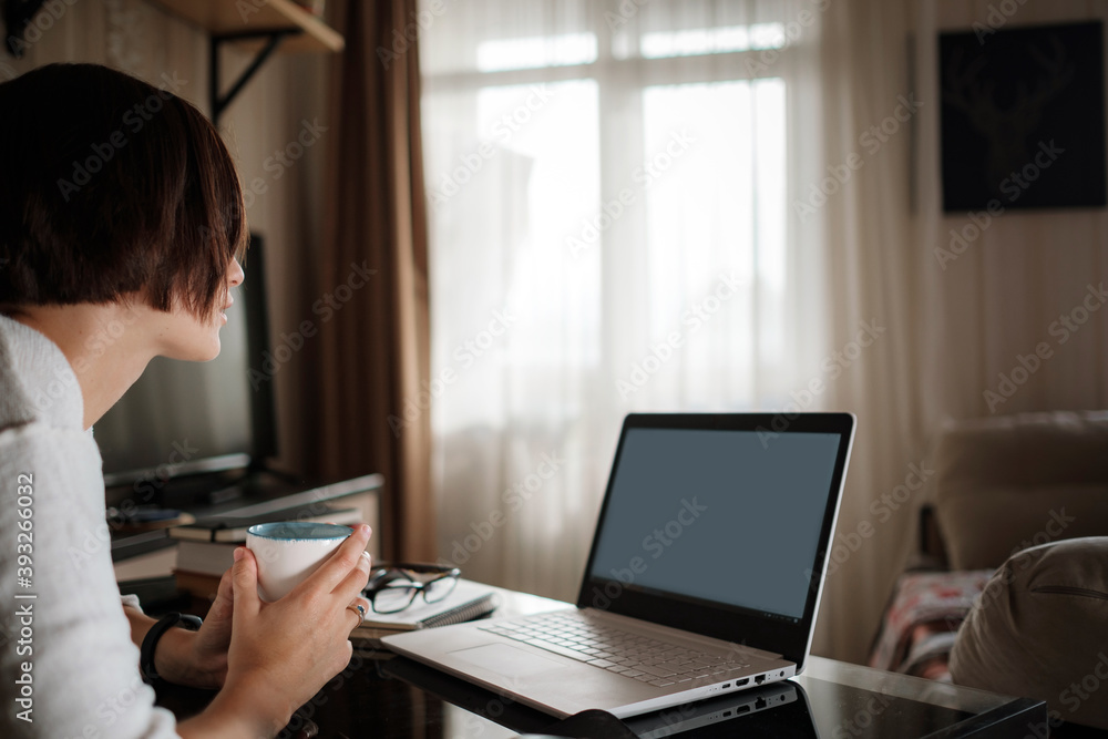 Smiling young asian woman video calling on laptop. Smiling young asian woman video calling on laptop.