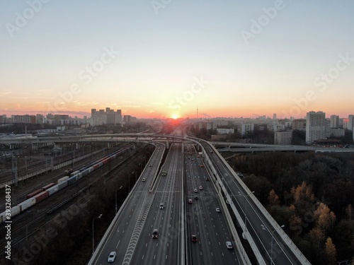 Aerial view panorama of multi-level transport interchange in the center of the big city at dawn. Beautiful panoramic landscape infrastructure of modern city from great height © Max