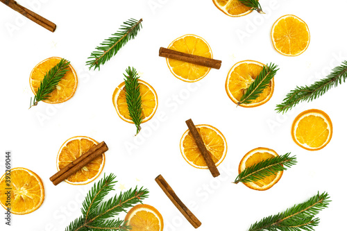 Composition of cinnamon, fur tree branches and dried oranges on white background. Flat lay, top view. Copy space for your design. Christmas or New Year concept.