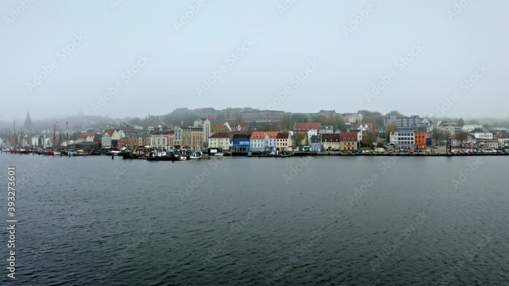 Drone flight over foggy Flensburg port and the small town overview, Germany Drone flight over foggy Flensburg port and the small town overview, Germany