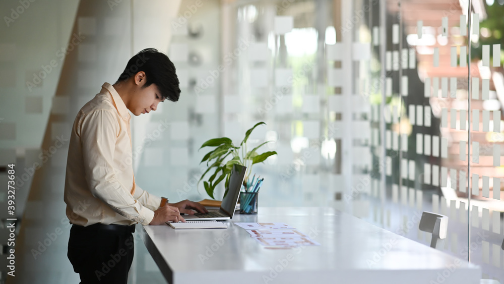 Fototapeta premium Web designer UX UI designer man is planning application for mobile phone in modern office.