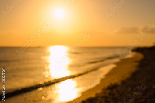Fototapeta Naklejka Na Ścianę i Meble -  Sunset over the seashore. Background on the theme of the sea and nature. Image is out of focus