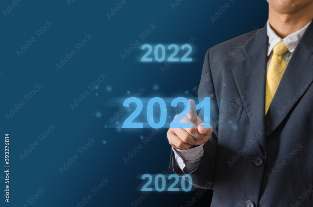 businessman hand touching on 2021 virtual screen. businessman hand touching on 2021 virtual screen.