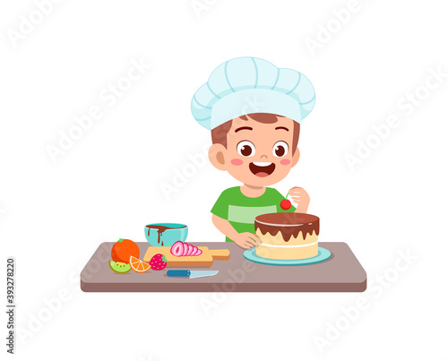 happy cute little kid boy and girl wear chef uniform and cooking a birthday cake