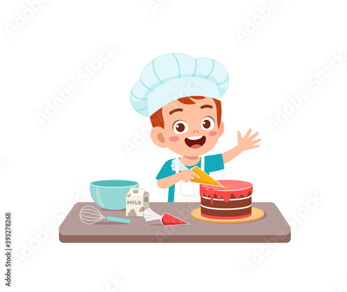 happy cute little kid boy and girl wear chef uniform and cooking a birthday cake