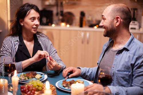 Happy young couple with pregnancy news during romantic dinner, Excited couple smiling, ar for this great news. Pregnant, young wife happy for result embracing man.
