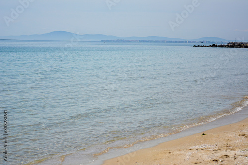 Ravda Bulgaria. May 20 2014. Empty seashore with distant mountain in the horizon. Sandy beach with calm transparent water.