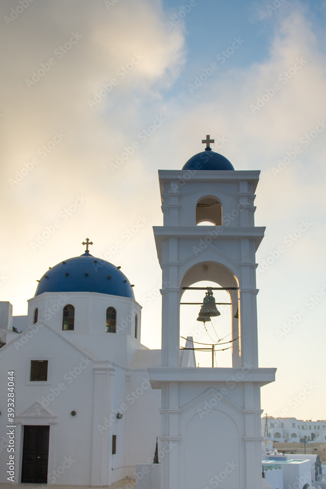 Blue dome church with a bell tower in Imerovigli village, Santorini island