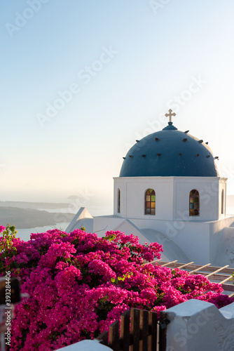 Blue dome church with a bell tower in Imerovigli village, Santorini island