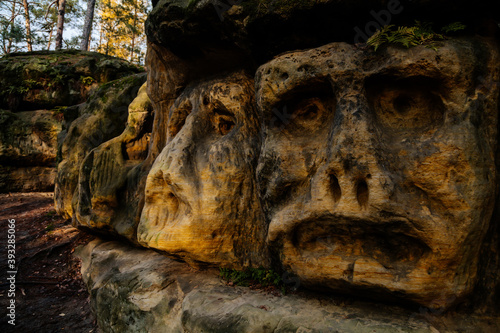 Monument sandstone rock sculptures and Harfenice (Harfenist) cave created by Vaclav Levy between Libechov and Zelizy, Cliff carvings carved in pine forest, Czech republic photo