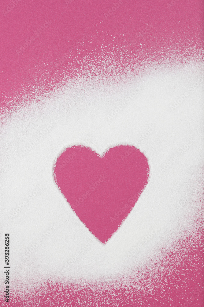 Collagen powder is scattered on pink paper background. Heart-shaped free space in the middle
