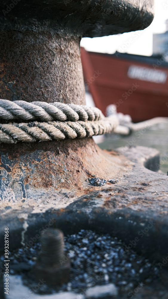 Fototapeta premium boat is attached to a steel bollard in the harbour with a large rope