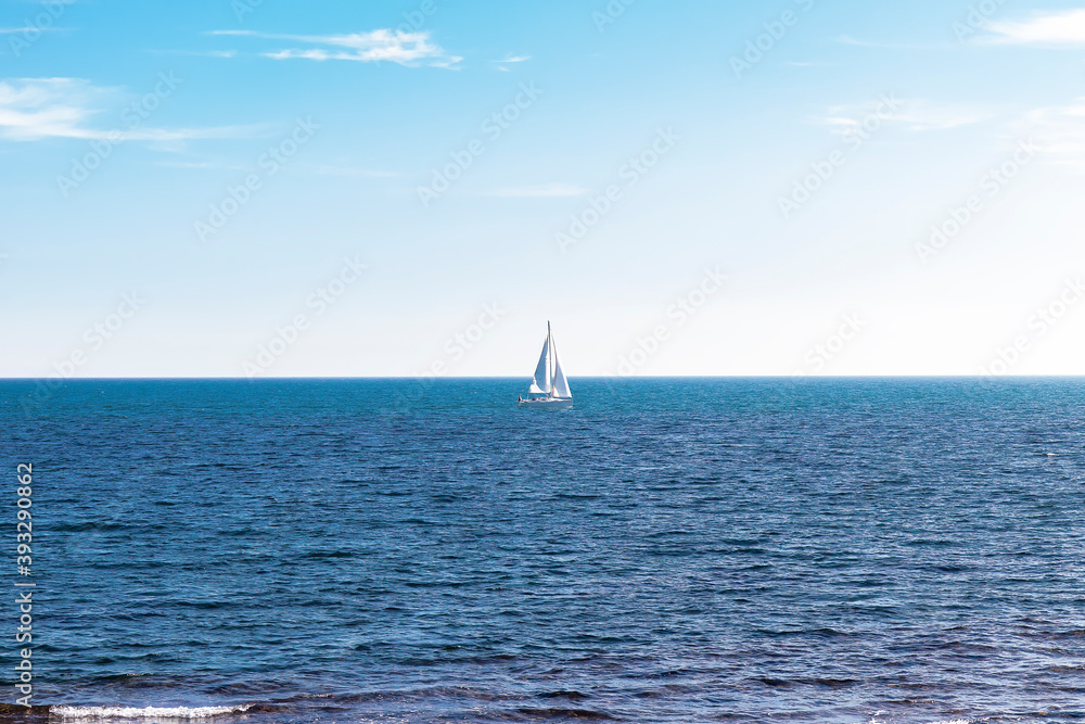 Sailboat yacht in the Mediterranean Sea with a blue sky on the background