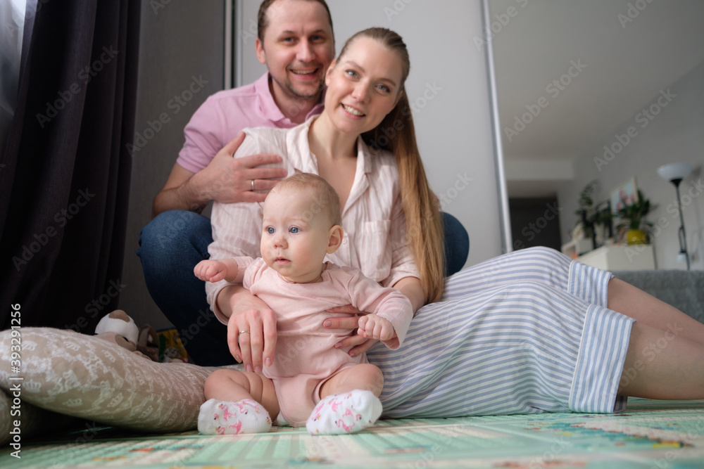 Portrait of happy young parents with baby at home Portrait of happy young parents with baby at home