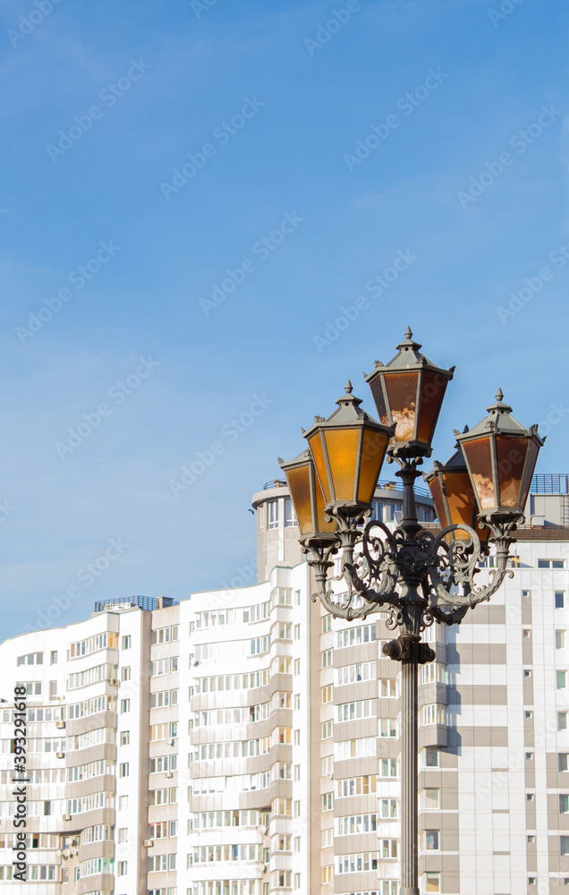 Large lantern against the background of a white modern building
