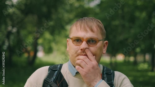 Nerdy fat guy is walking to school. Concept of loser nerd at university. Close up