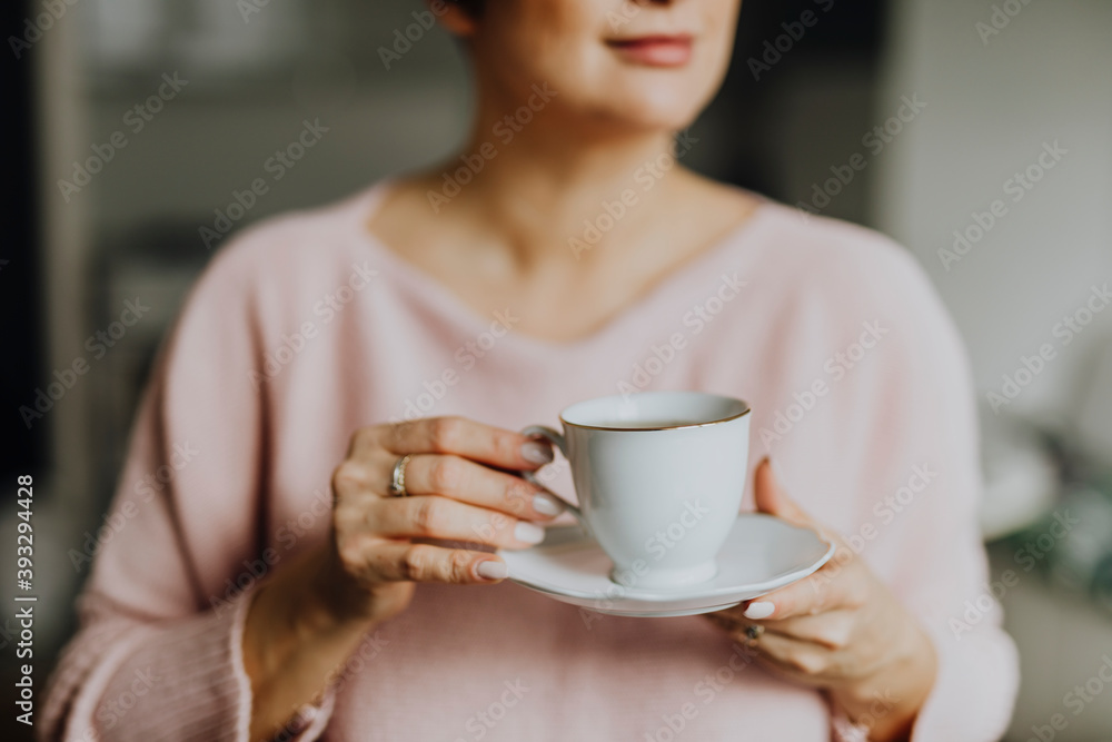 Happy woman enjoying a warm cup of tea for breakfast Happy woman enjoying a warm cup of tea for breakfast