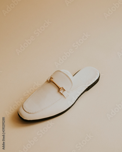 White lather loafer mules shoes on beige photo